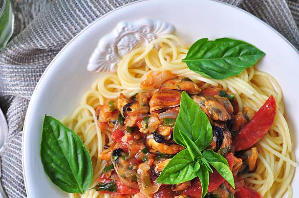 istock pasta with mussels, pepperoni, bacon, tomato and basil 492073332