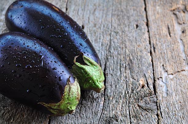 istock organic eggplants on a wooden background 492074898