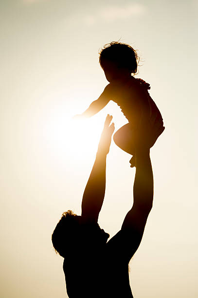 istock Father Tossing Daughter in the Air 492077380