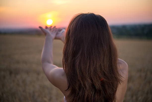 istock girl raised her hands to sunset 492077682