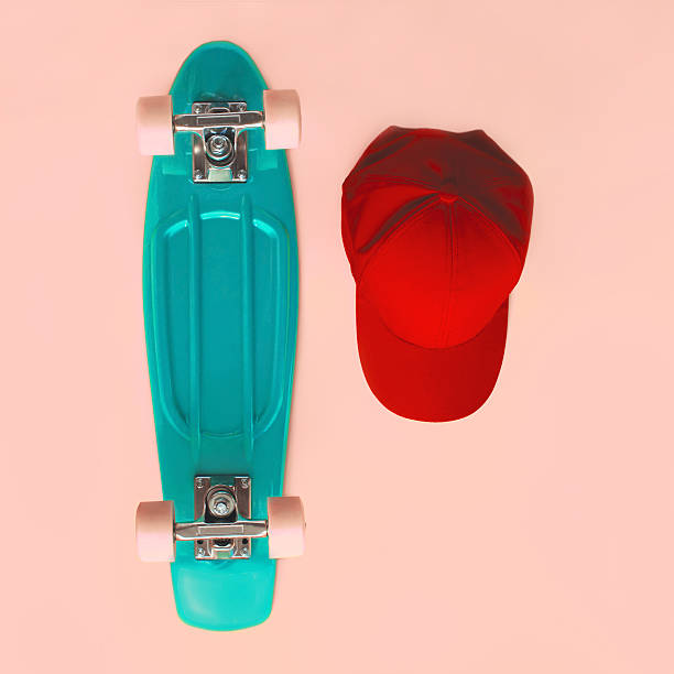 istock Fashion set. Skateboard and baseball cap on pink background 492078044