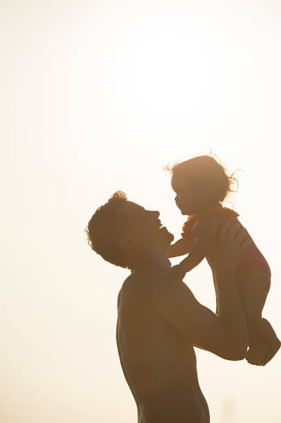 istock Father Holding Daughter Up in the Sunset 492078064
