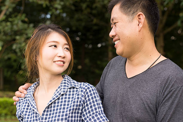 istock young Asian couple smile and hug each other 492078194