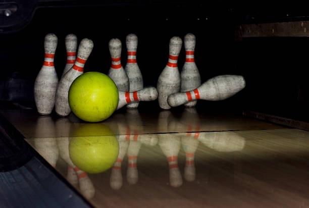 istock Bowling ball strike pins in front of dark background 492078442