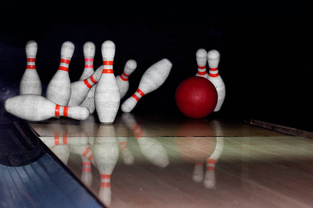 istock Bowling ball strike pins in front of dark background 492078456
