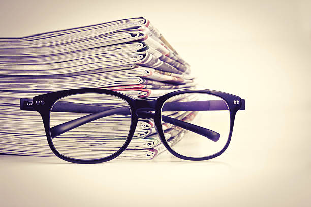 istock selective focus on reading eyeglasses with stacking of newspaper 492082672