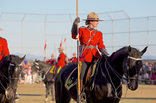 White Rock, British Columbia, Canada — 26 July 2013. Female Royal Canadian Mounted Police officer, RCMP, mounted on horseback during the Musical Ride performance