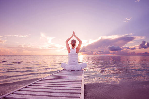 istock Caucasian woman practicing yoga at seashore 492092510