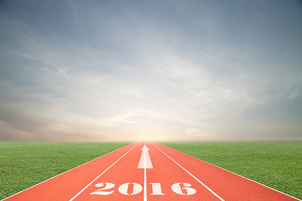 istock Running track with green grass and blue sky white cloud. 492093650