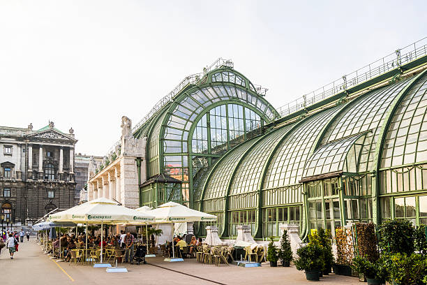 Vienna, Austria - August 31, 2013: Butterfly House in Hofburg Park. People sitting in a oudoor restaurant, relaxing, drinkng and eating.