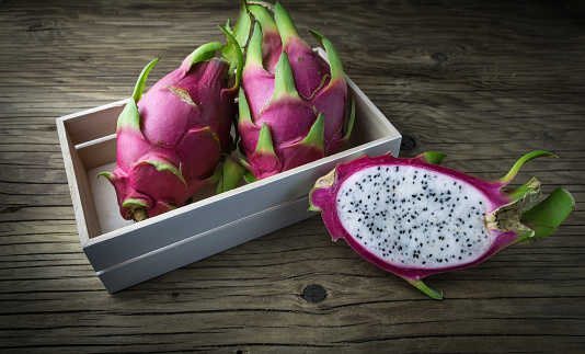 Dragon Fruit On old Wooden Table, Selective focus.