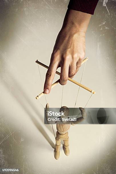 Hand Manipulating A Puppet Stock Photo - Download Image Now - Marionette, Puppet, Authority