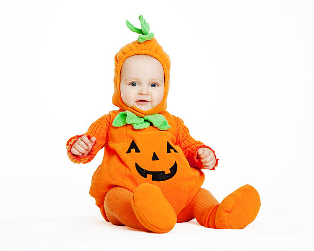 istock Child in pumpkin suit on white background 492096078