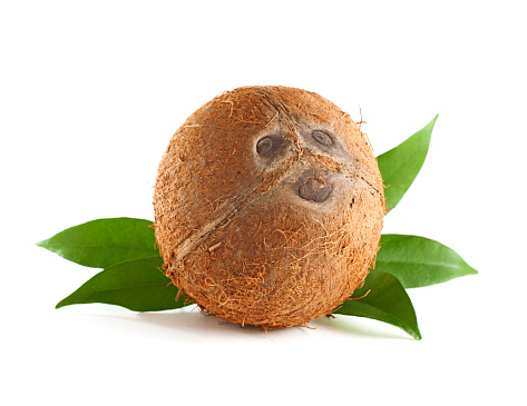 Whole coconut with leaves isolated on white