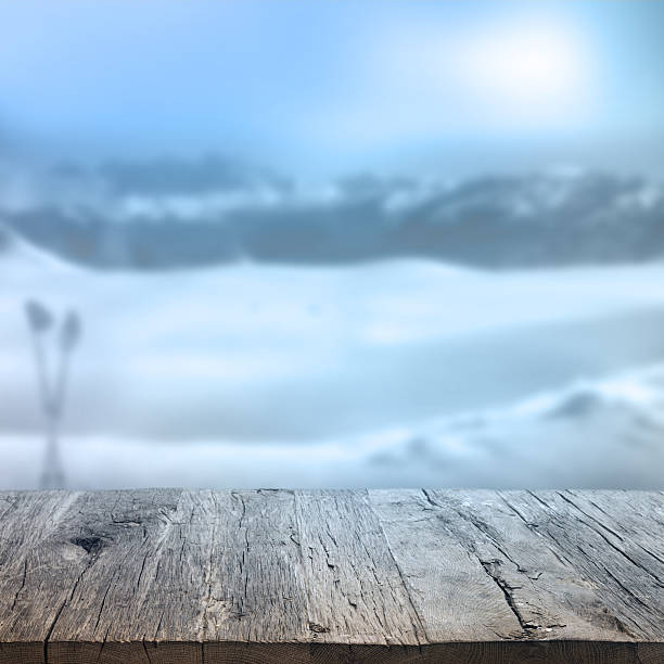 Wooden table with winter background Wooden deck table over beautiful winter background apres ski stock pictures, royalty-free photos & images