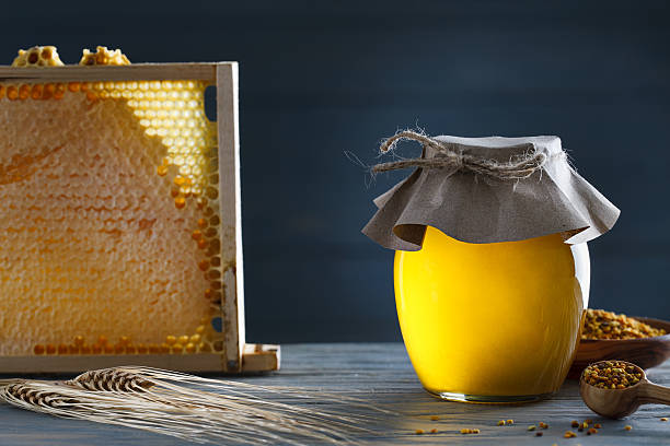istock Honey jar with honeycombs and pollen 492099718