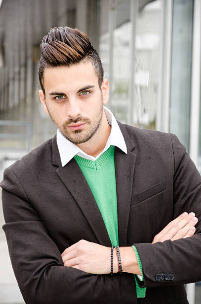 istock businessman standing arms crossed 492100190