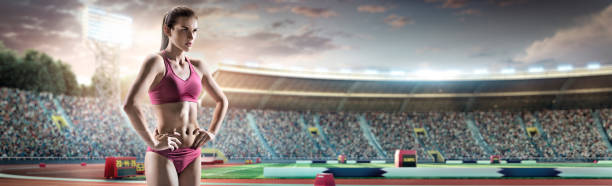 Female athlete standing on a running track