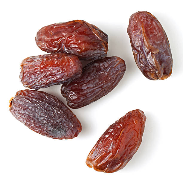 Medjool dates Medjool dates from above isolated on white background dried fruit on white stock pictures, royalty-free photos & images