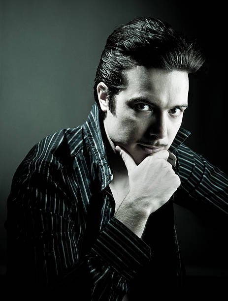 High contrast black and white portrait of a man looking into the distance. (Focus is on the lower half of the mans face)