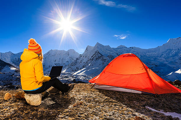 Young woman using laptop in Himalayas, Nepal