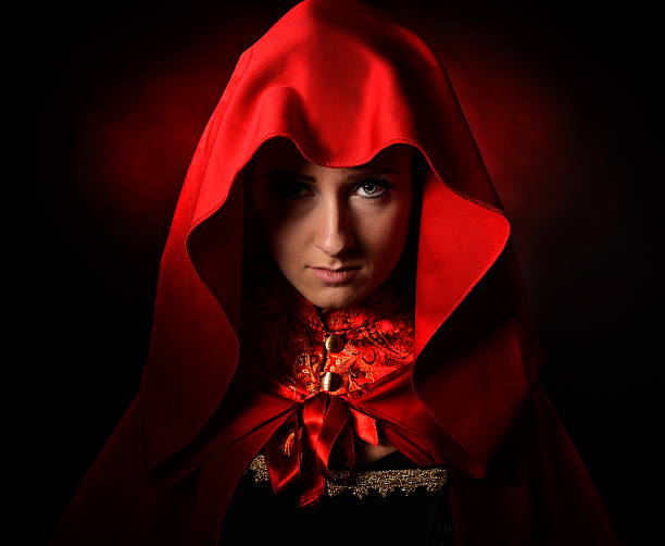 istock beautiful woman with red cloak in studio 492105458