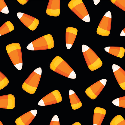 Vector seamless pattern with candy corn on a black background.