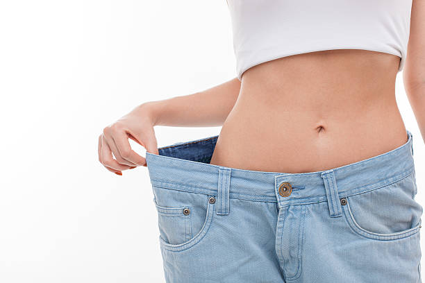 istock Fit young healthy woman is dieting successfully 492107874