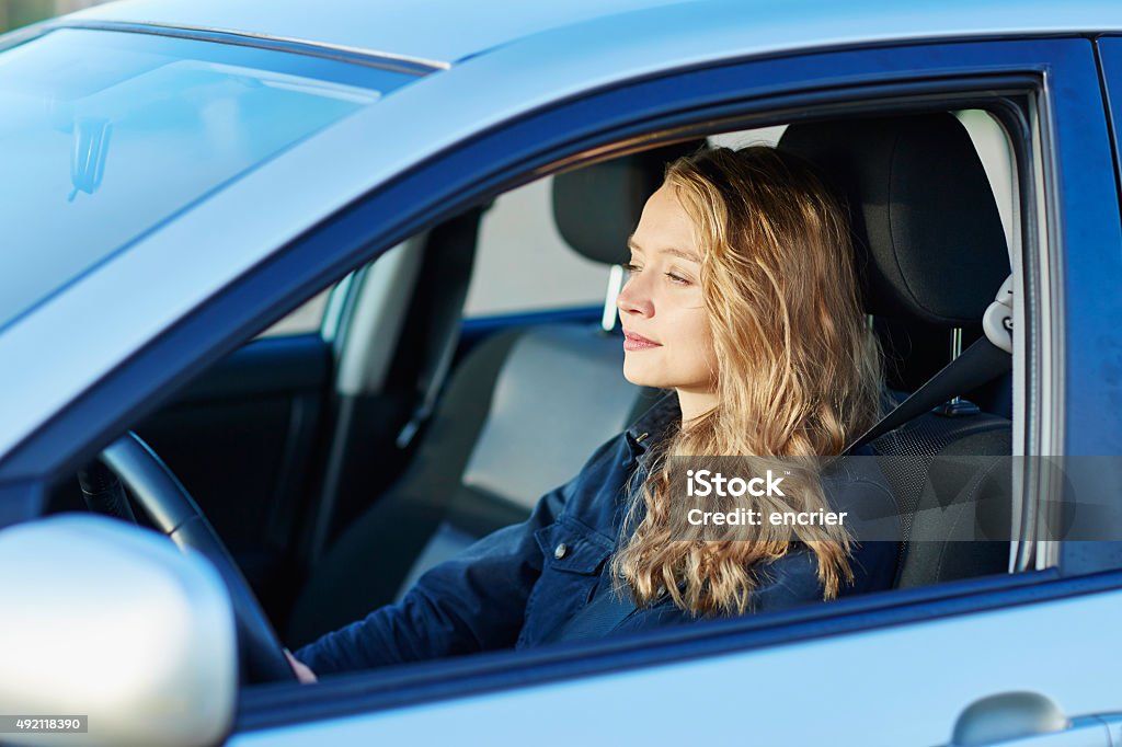 Young confident woman driving a car Beautiful young confident woman driving a car 2015 Stock Photo