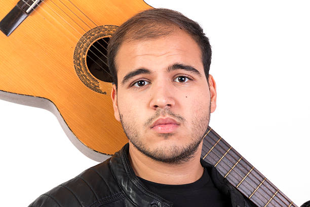 istock Young Man With an Old Acoustic Guitar 492118966