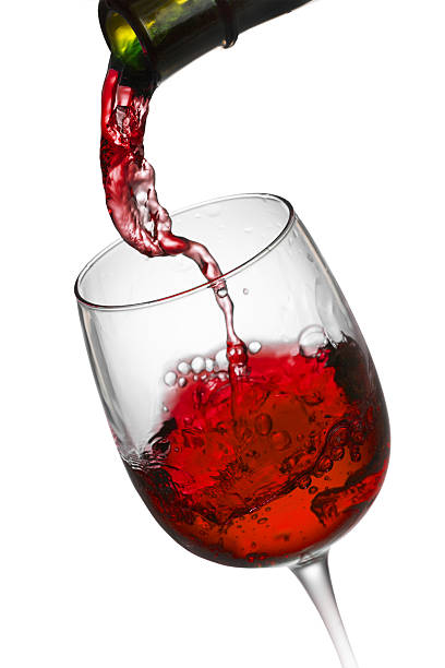 istock red wine pouring in glass isolated on white background 492121508