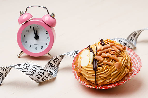 istock Sweet food measuring tape and clock on table 492124970