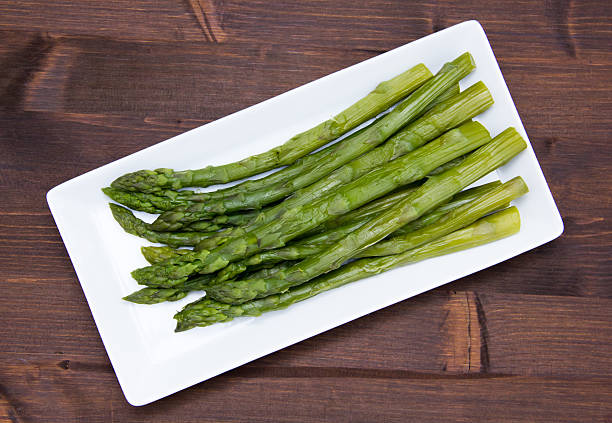 istock Asparagus over wooden tray on top 492125496