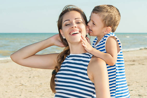 istock Happy beautiful mother and son enjoying beach time 492126638