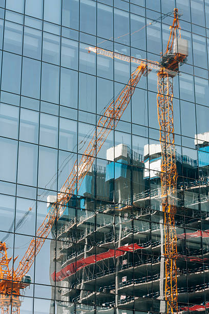 istock reflection, crane working in construction site, building and carrying 492126964