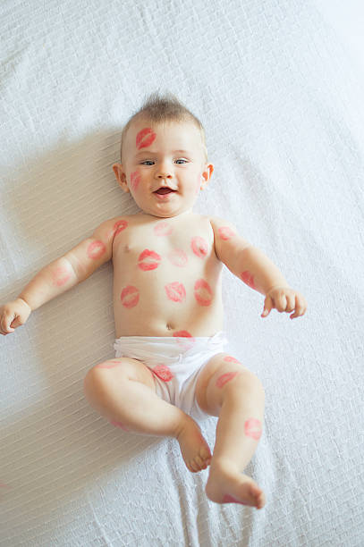 istock Baby covered with red kisses 492127962