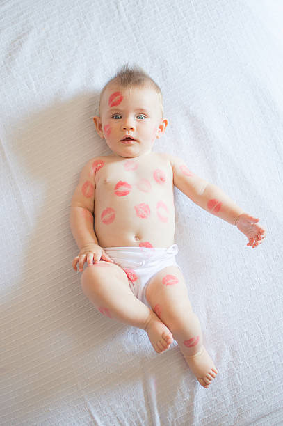 istock Girl baby covered with red kisses 492128264