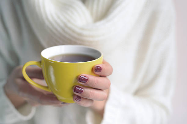 istock Cup of tea or coffee in female hands 492128434