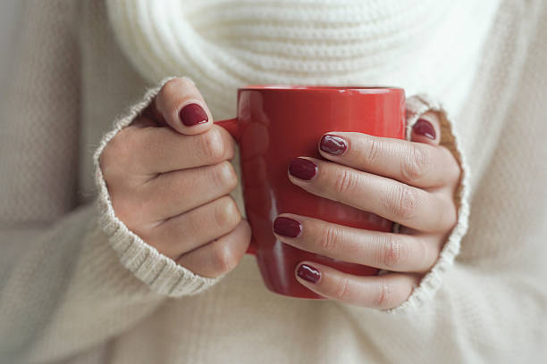 istock Cup of tea or coffee in female hands 492128448