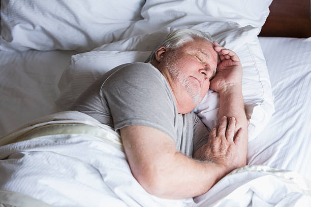 istock Senior man sleeping in bed 492129814