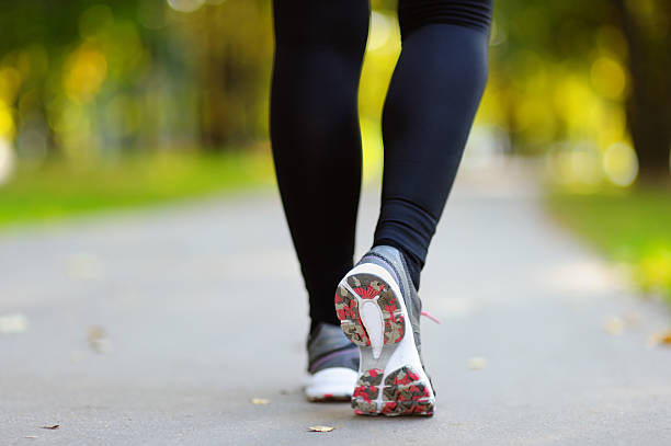 istock Runner feet running on road closeup shoe 492130098