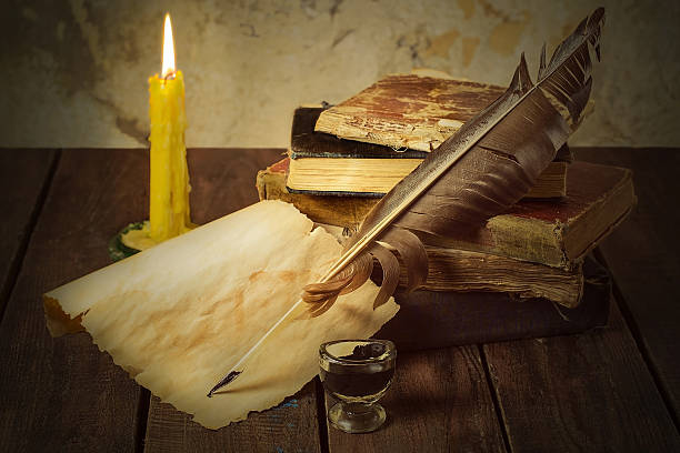 istock Old books, candle and feather with inks 492130740