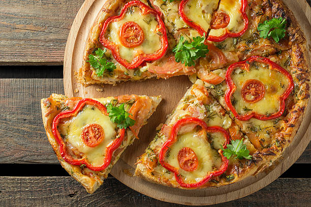 istock Pizza with pepper and chicken on a wooden background 492130792
