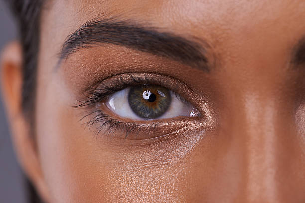 She's got her eye on beauty Closeup portrait of a beautiful young woman in the studio green eyes photos stock pictures, royalty-free photos & images