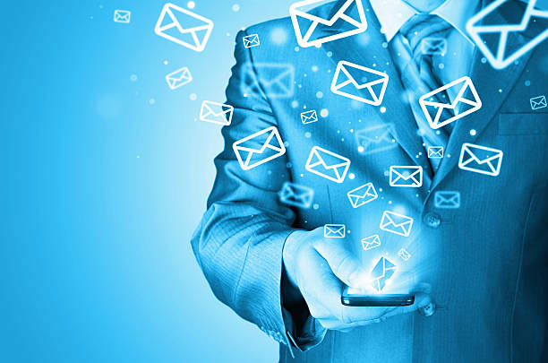 istock Business man holding smart phone and sending emails 492144913