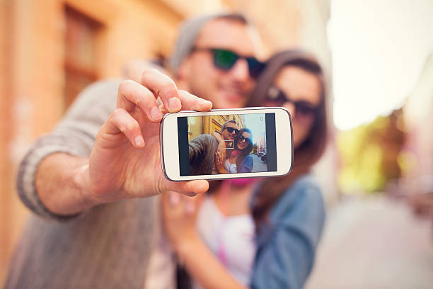 istock Young couple taking selfie in the city 492145443