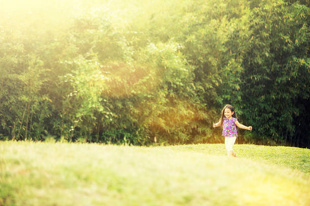istock Running girl on green field 492146293