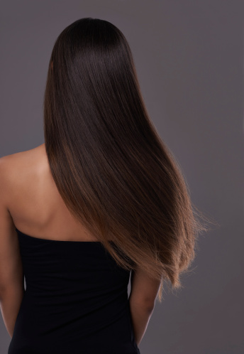 Rear view of a young woman with beautiful long hair