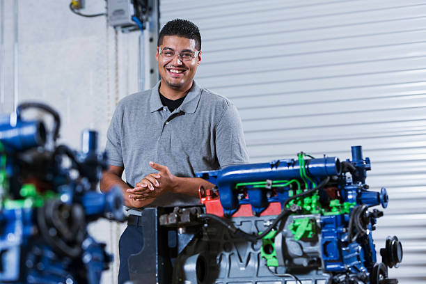 istock Hispanic man in auto mechanic school with diesel engine 492147198