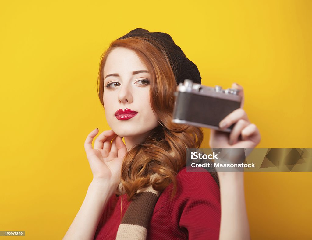 Redhead girl with retro camera Adult Stock Photo